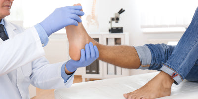 A podiatrist examining a patient’s foot