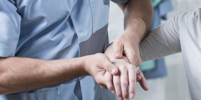 Physical Therapist examining a patient’s wrist