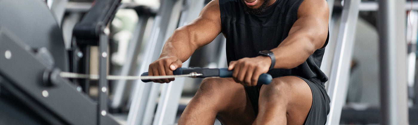 Man working out in a gym on rowing machine