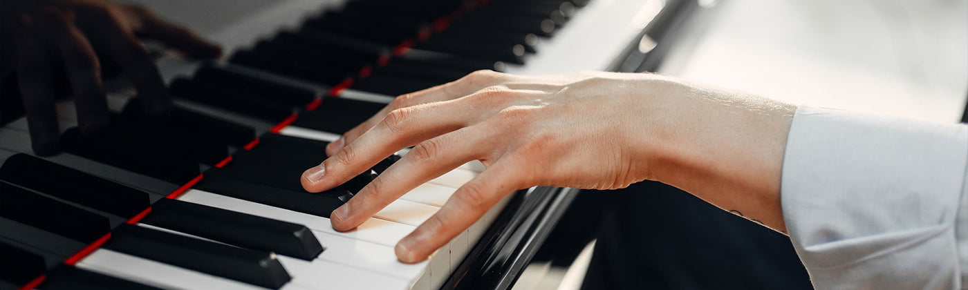 Man's hand playing the piano