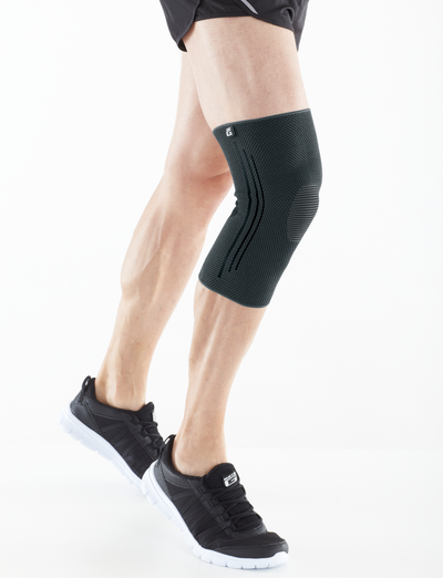 A man wearing an Airlfow React Knee Support in a white studio