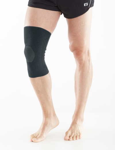 A man wearing an Airlfow React Knee Support in a white studio
