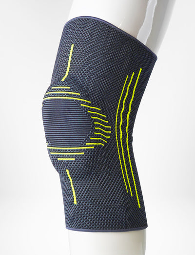Leg mannequin wearing Neo G Active Plus Knee Support left side on an angle showing the silicone patella cushion