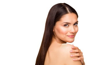 Woman holding arm with Neo G Opti-Heal Silicone Wound Recovery Strip on one shoulder
