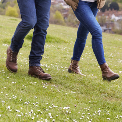 Two people walking on a field