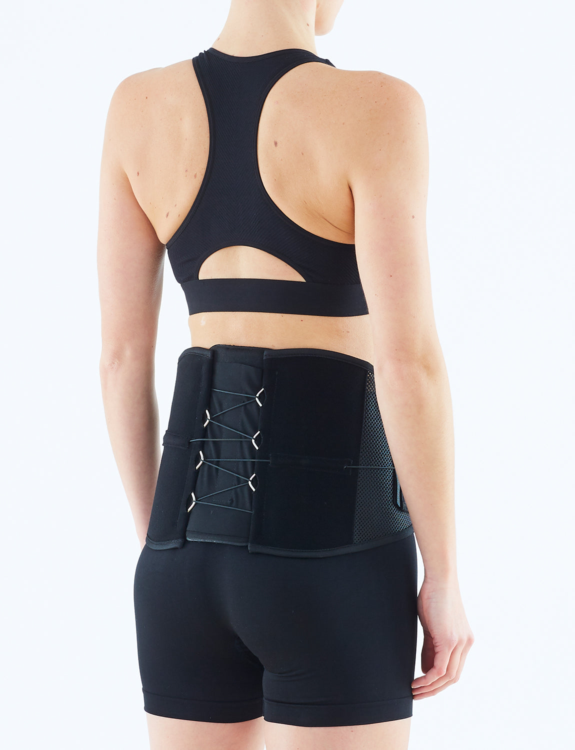 Woman wearing Neo G Adjusta-Fit Back Brace facing back