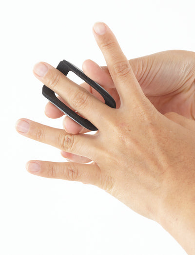 Hand with Neo G Easy-Fit Finger Splint open on middle finger, top view, highlighting flexible shell