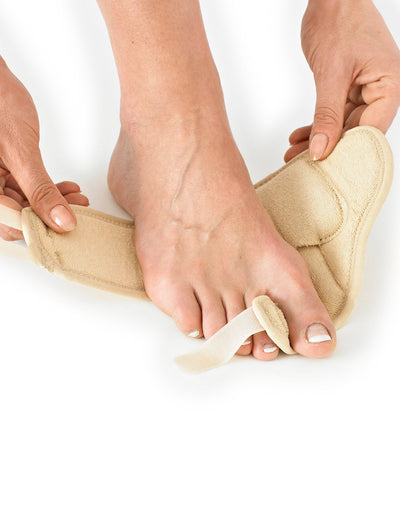 Hands putting Neo G Bunion - Hallux Valgus Soft Support onto right foot highlighting adjustable big toe support