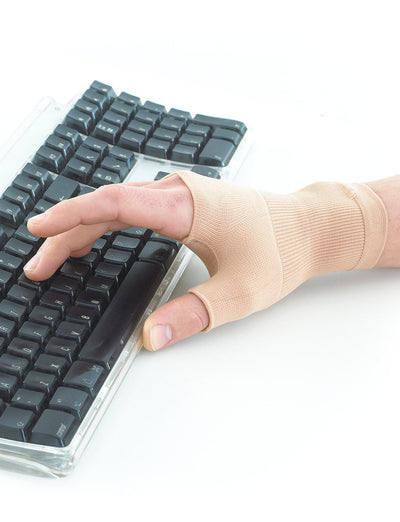Hand wearing beige Neo G Airflow Wrist & Thumb Support, typing