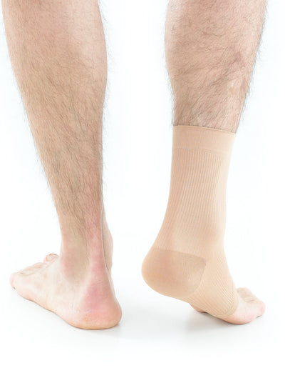 Pair of feet with one wearing beige Neo G Airflow Ankle Support
