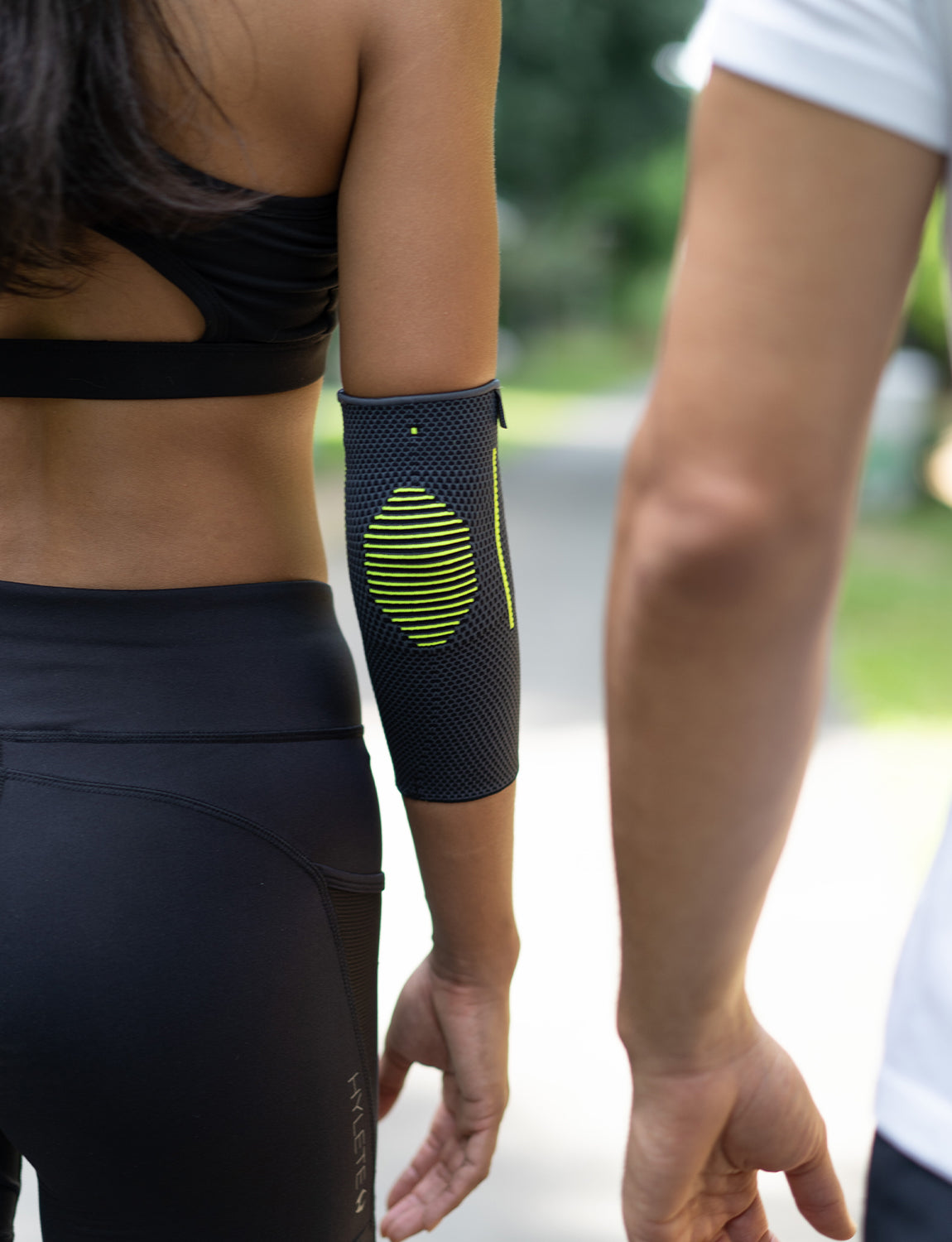 Woman wearing Neo G Active Elbow Support exercising facing back