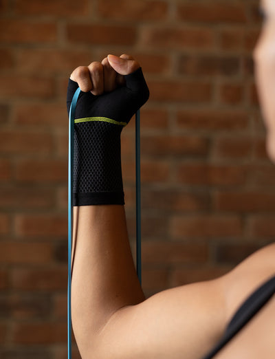 Woman wearing Neo G Active Wrist Support with hand in fist