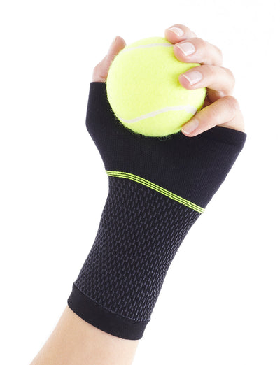 Hand wearing Neo G Active Wrist Support palm up, holding a tennis ball