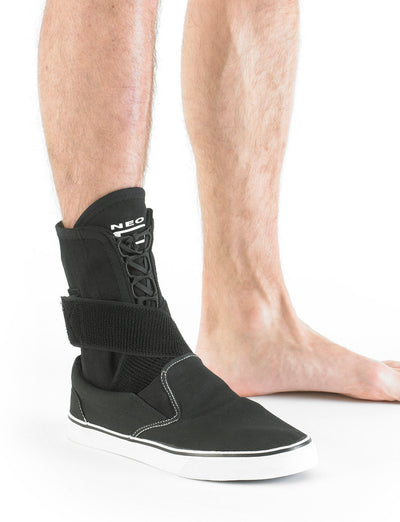 Leg wearing Neo G Laced Ankle Support under a shoe