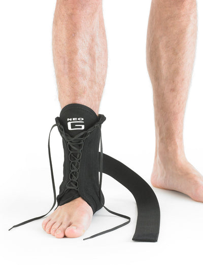 Leg wearing Neo G Laced Ankle Support facing front showing wrap around figure of 8 strap
