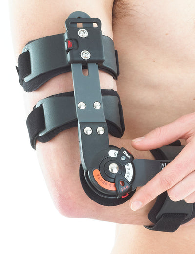 Man wearing Neo G Post Operative Elbow Brace highlighting easy to operate dial for accurate flexion and extension control