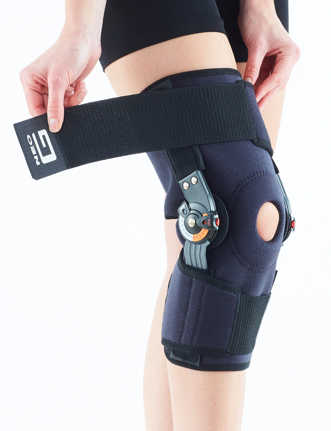 Leg wearing Neo G Adjusta-Fit Hinged Knee Brace highlighting adjustable straps