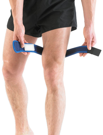 Man putting on Neo G ITB Strap on thigh showing premium quality silicone vibration dampening pad