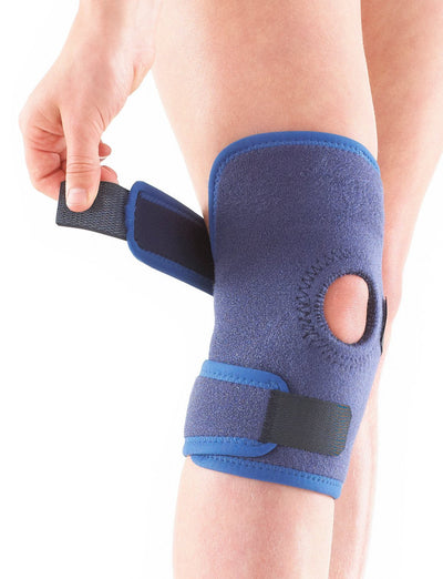 Child wearing Neo G Kids Open Knee Support, facing front, highlighting the adjustable strap
