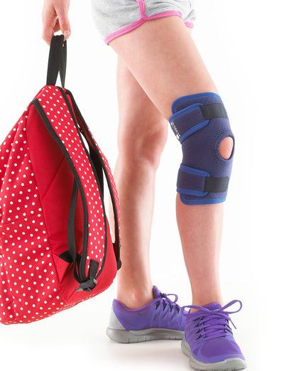 Child wearing Neo G Kids Open Knee Support, holding a backpack