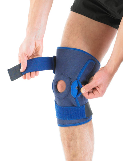 Man wearing Neo G Hinged Open Knee Support highlighting adjustable straps and geared hinge system