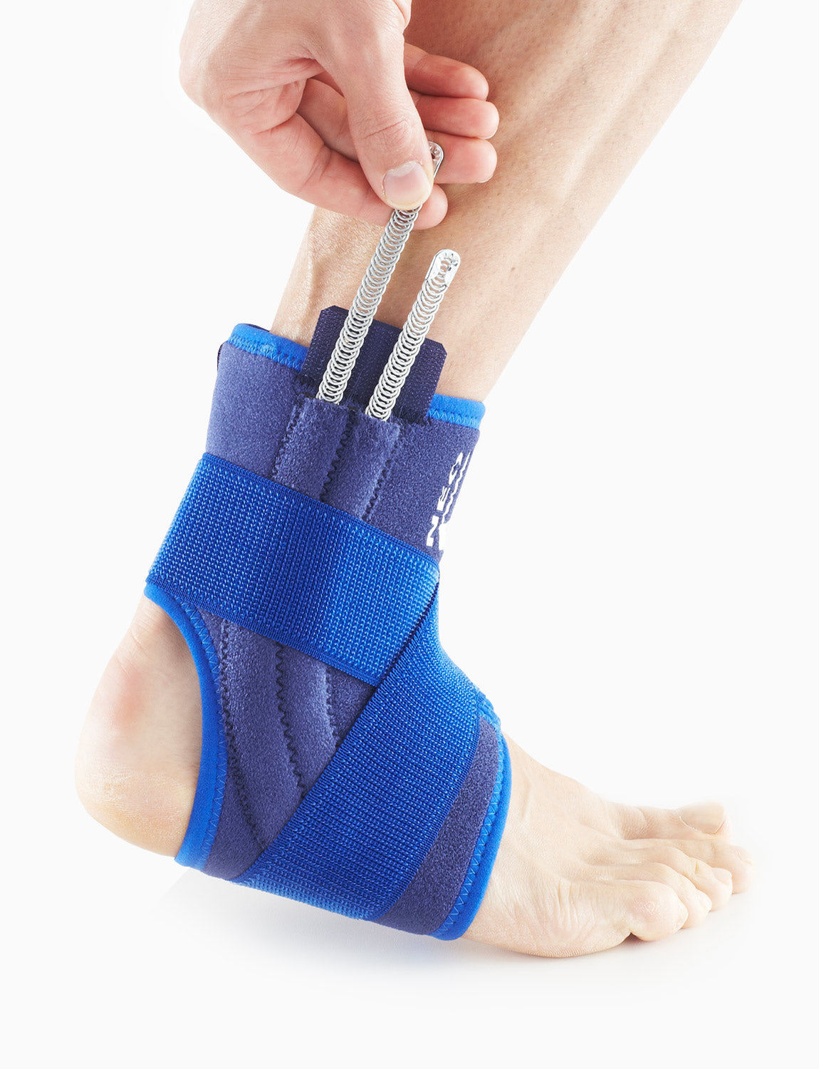 Foot wearing Neo G Stabilized Ankle Support with Figure of 8 Strap facing side highlighting the interchangeable metal spiral stays