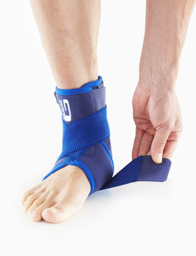 Foot wearing Neo G Stabilized Ankle Support with Figure of 8 Strap highlighting the adjustable strap