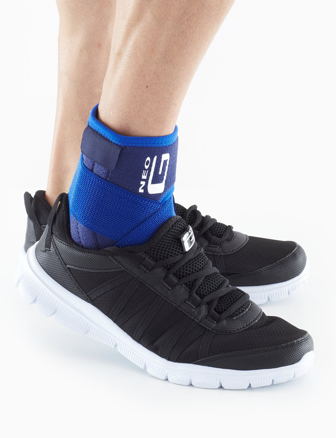 Foot wearing Neo G Stabilized Ankle Support with Figure of 8 Strap under sneakers