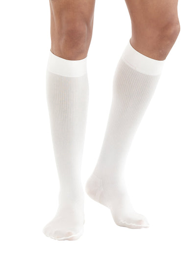 Woman wearing White Neo G Energizing Dress Socks showing comfort top band, and reinforced toe