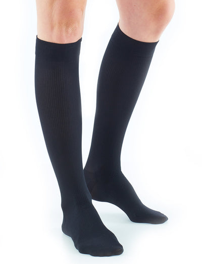 Woman wearing Neo G Energizing Dress Socks, facing front, showing comfort top band