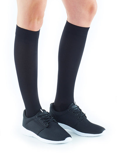 Woman wearing Neo G Energizing Dress Socks with sneakers