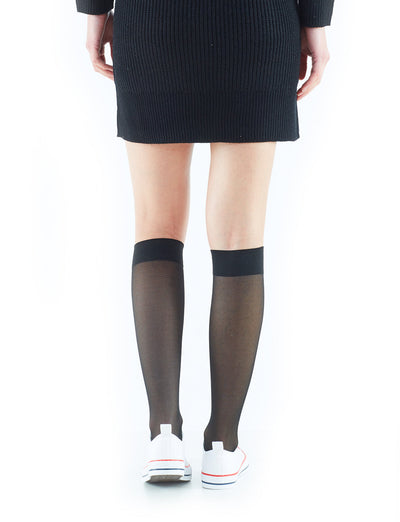 Woman wearing Black Neo G Energizing Trouser Knee Highs with sneakers, facing back