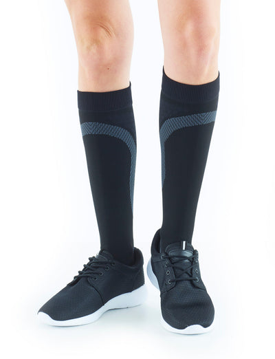 Woman wearing Black Neo G Energizing Active Socks with sneakers, facing front 